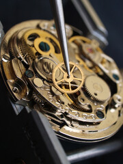 close up pic of watchmaker repairing vintage watch mechanism
