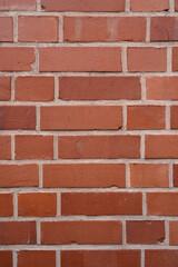 Obraz premium Wall with red bricks as a background with copy space in vertical format