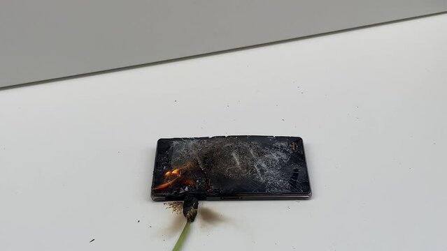 Broken phone. Hammer hitting the display breaks the mobile phone. Mobile smartphone with a broken screen. Drop Test. Hammer Durability. Hammer vs mobile display. Smashing the Phone. Breaking display.