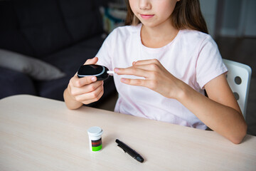 Child girl checking blood sugar level by Digital Glucose meter. Health care and Medical, diabetes, glycemia concept