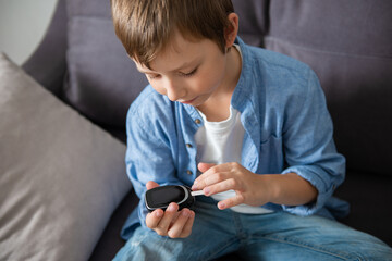 Child boy checking blood sugar level by Digital Glucose meter. Health care and Medical, diabetes,...