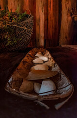 A long bowl containing seashell artifacts is on display in a replica Iroquois longhouse at Crawford...