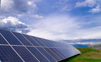 Solar power plant farm on the background of the sky. Blue solar panels, alternative source of...