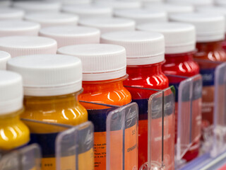 Paint cans on the shelf at the store.
