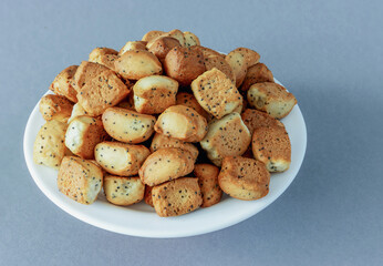 Kuciukai are traditional Lithuanian Christmas cookies on a plate on a gray background