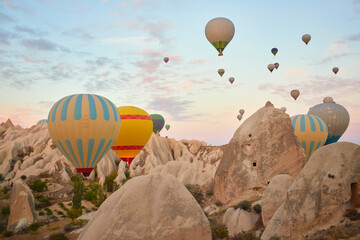 Hot air balloons flying in sunset sky Cappadocia, Goreme, Turkey. Great tourist attraction -...