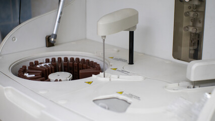 A laboratory biochemical analyzer analyzes blood serum samples. The automatic machine itself mixes...