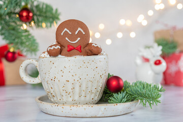 Fototapeta na wymiar Gingerbread cookie man with a hot chocolate for Christmas. Traditional holiday symbol. Christmas holiday background.