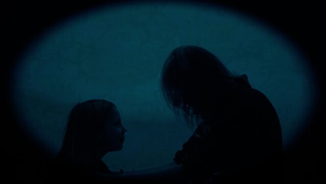 Mom emotionally screams at her daughter and waves her arms. She expresses her dissatisfaction with the behavior of the child. Specially subdued lighting, the view, as it were, from the keyhole.