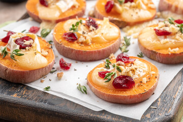Baked Sweet Potato Rounds topped with brie cheese, cranberry and Walnut. Thanksgiving appetizer...