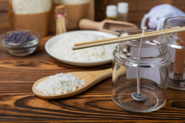 Ecological and vegan handmade soy wax candles with wooden wick. Transparent container, essential oil, soy wax, matches and dried flowers. MOCKUP, space for text. Handmade craft candles.