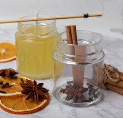 Soy candles handmade with wooden wicks. Handmade craft candles. Vegan product. Glass jars with soy wax on a marble table.