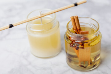 Soy candles handmade with wooden wicks. Handmade craft candles. Vegan product. Glass jars with soy wax on a marble table.