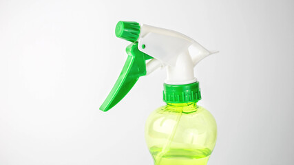 green spray bottle on white background