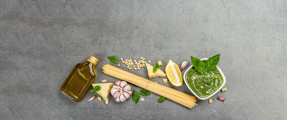 Traditional ingredients for the preparation of classic Italian pasta. Dry spaghetti, basil pesto