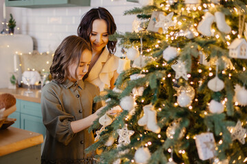 Mother and daughter decorate the house for Christmas. Decorate the Christmas tree for the holiday. Love and understanding in the family. together in the new year. Lifestyle live moment. Christmas Eve 