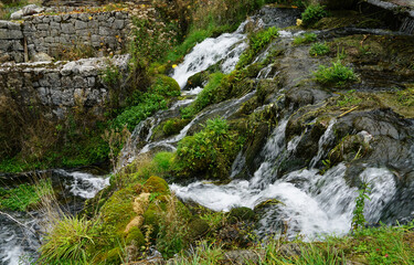 Water flowing in streams and waterfalls from the mountain to the valley