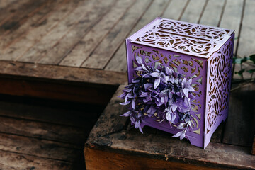 purple open gift box on wooden floor