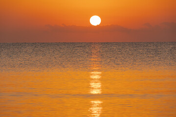 sunrise over the horizon in the sea