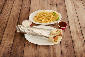 A Pakistani kebab restaurant menu with stuffed durum and curly fries with sauces