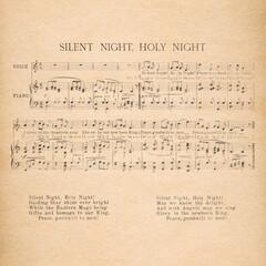 Christmas carol. Old music sheet Silent Night. Used paper background