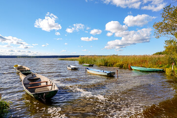 Fototapeta premium Beautiful sunset view of old boats on the lake.