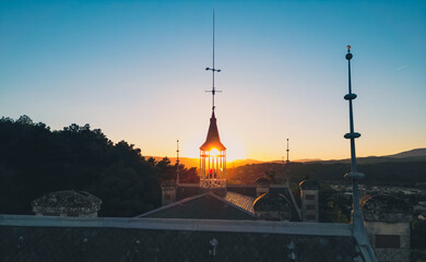 Weather vane on the roof of the castle at sunset