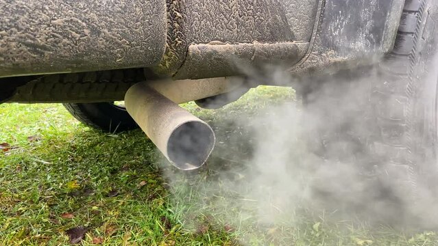 Smoke emissions from Car exhaust pipe, clog air pollution. Toxic fumes of engine car. Combustion gases out of the exhaust pipe of a car. Air pollution from exhaust pipe. Emission Pollution and Co2.