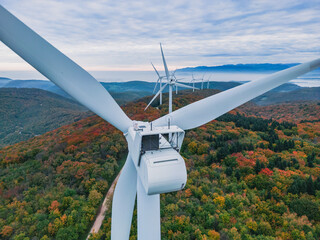 Close-up on the propellers of a wind turbine during a misty morning and sunrise. Green energy. Wind...