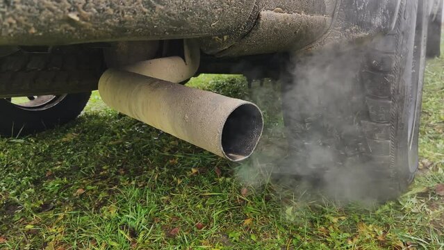 Smoke emissions from Car exhaust pipe, clog air pollution. Toxic fumes of engine car. Combustion gases out of the exhaust pipe of a car. Air pollution from exhaust pipe. Emission Pollution and Co2.