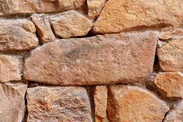Stone wall background with rough texture