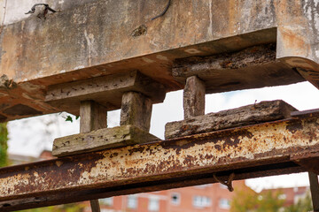 Broken wooden supports of metal beams of the bridge engineering structure