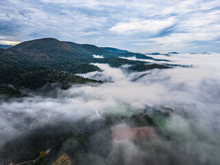 Thick morning fog covering the valley between the surrounding mountains in southern France, autumn season