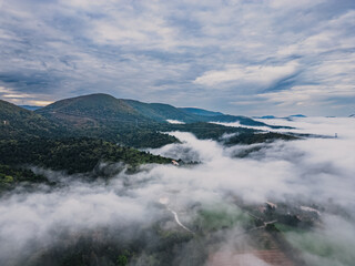 Thick morning fog covering the valley between the surrounding mountains in southern France, autumn season
