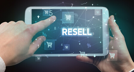 Close-up of a hand holding tablet with shopping inscription