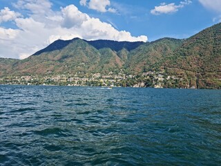 Fototapeta premium Lake Como country on a summer sunny day. View of the bay. Lake Como and mountains. Scenic view of the resort town. Beautiful Italian landscape.