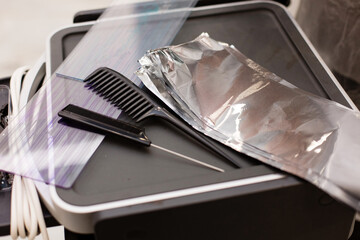 Hairdressing set with hair dye, foil and brush on the table in the barber shop