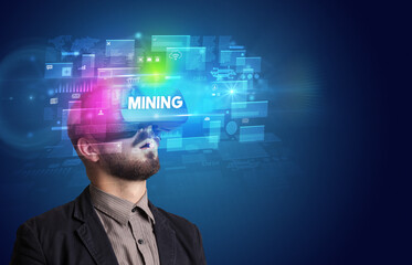 Businessman looking through Virtual Reality glasses