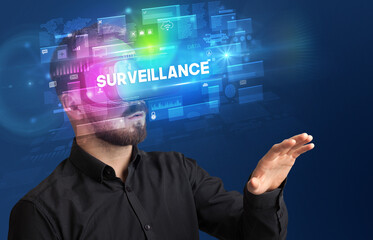 Businessman looking through Virtual Reality glasses