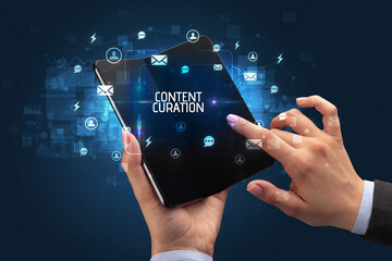 Businessman holding a foldable smartphone, social media concept