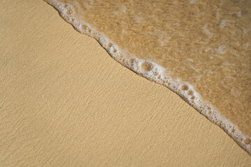 Fototapeta na wymiar Waves with foam on the Atlantic coast in Cape Verde.