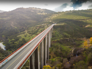 aerial view of a bridge over which cars and trucks pass