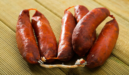 Traditional Spanish chorizo sausages on wooden background