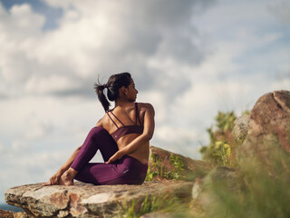 Yogini dancing and practicing yoga outdoors on a mountain in India. Mindful yoga practice. Lotus pose. Meditation. Improvisation. Contemporary dance.