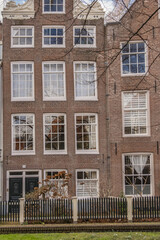 Naklejka premium World Famous historic Begijnhof (Beguinage, 1346) is one of the oldest courts in the city of Amsterdam. Begijnhof founded during the middle Ages. Amsterdam, the Netherlands.