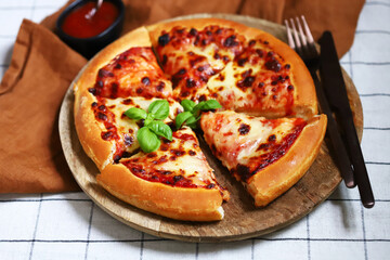 Round pizza margarita on yeast dough. Delicious fresh pizza.