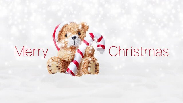 Merry Christmas text and teddy bear with red hat and candy striped cane stick isolated on snowing background, white Christmas concept template for greeting gift card or promotion advertising banner