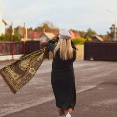 People from behind. Elegant woman in seasonal fall clothing