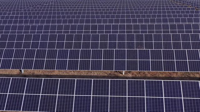 Large station solar panels farm, source of clean green renewable, sustainable energy. Aerial drone rising up shot in Elora Tennessee, USA.