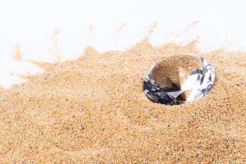 Big Carat Diamond Jewelry Gemstone on Sand Beach in Tropical Island beautiful summer sun on golden find sand, studio shot copy space